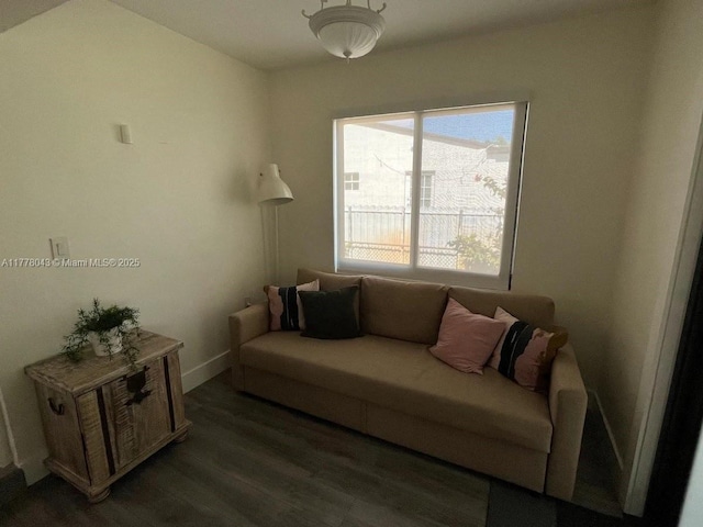 living area with dark wood finished floors and baseboards