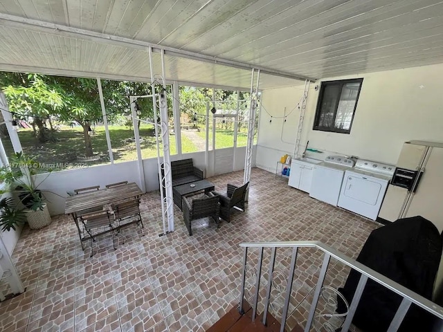 sunroom with washer and dryer and an outdoor living space