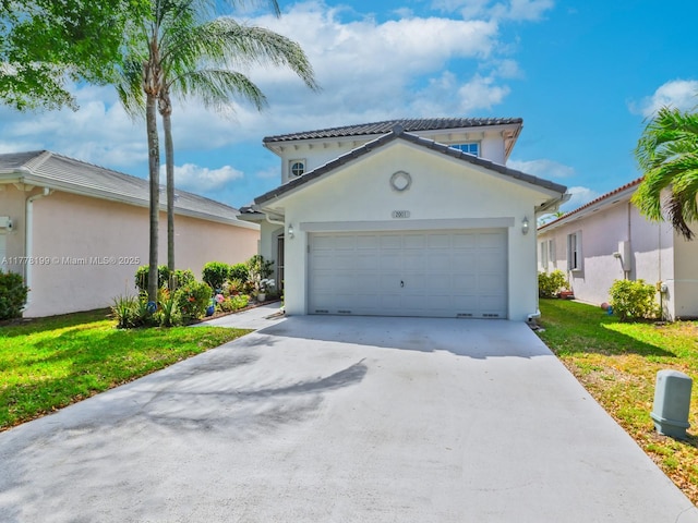mediterranean / spanish-style home with a front yard, a garage, concrete driveway, and stucco siding