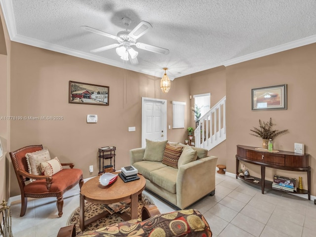 living room featuring a textured ceiling, stairs, ornamental molding, a ceiling fan, and light tile patterned floors