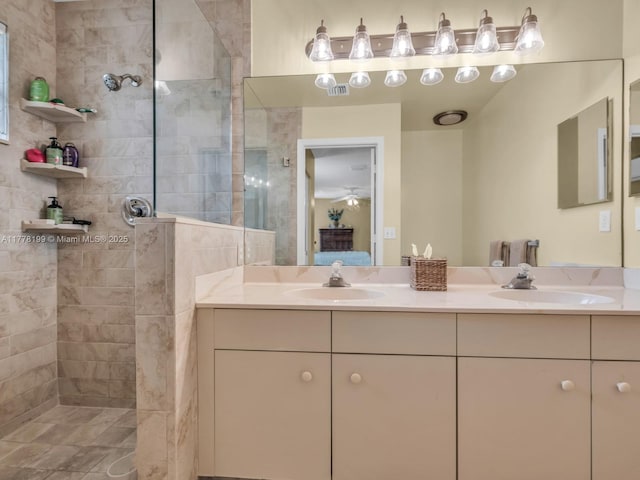 bathroom with double vanity, a sink, and walk in shower
