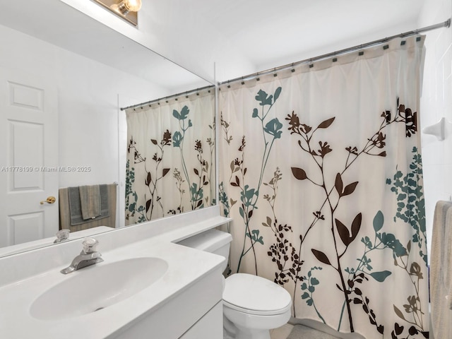 bathroom featuring curtained shower, toilet, and vanity