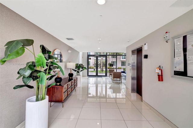 4740 NW 84th Ct Unit 32, Doral, FL 33166 - hall with floor to ceiling windows, french doors, elevator, light tile patterned floors, and visible vents