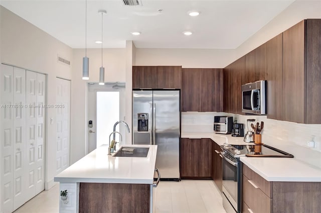 4740 NW 84th Ct Unit 32, Doral, FL 33166 - kitchen featuring light countertops, a sink, appliances with stainless steel finishes, modern cabinets, and visible vents