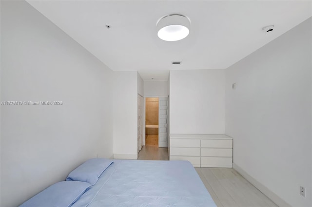 4740 NW 84th Ct Unit 32, Doral, FL 33166 - bedroom with light wood-type flooring, baseboards, and visible vents