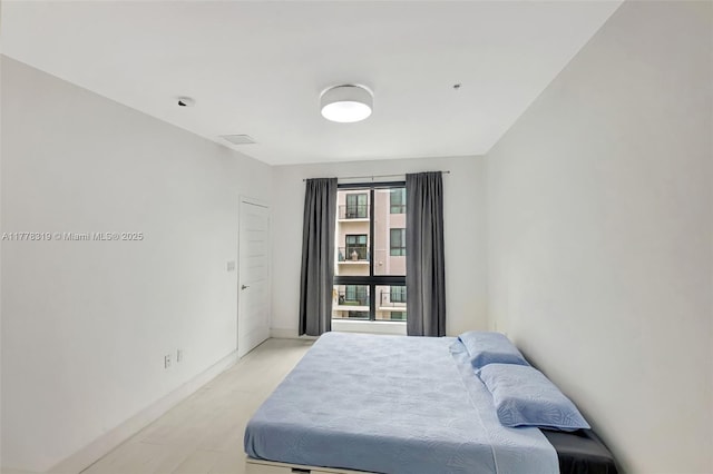 4740 NW 84th Ct Unit 32, Doral, FL 33166 - bedroom featuring baseboards and light wood-type flooring