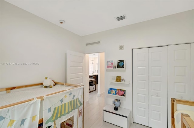 4740 NW 84th Ct Unit 32, Doral, FL 33166 - bedroom with visible vents, a closet, and light wood-style flooring