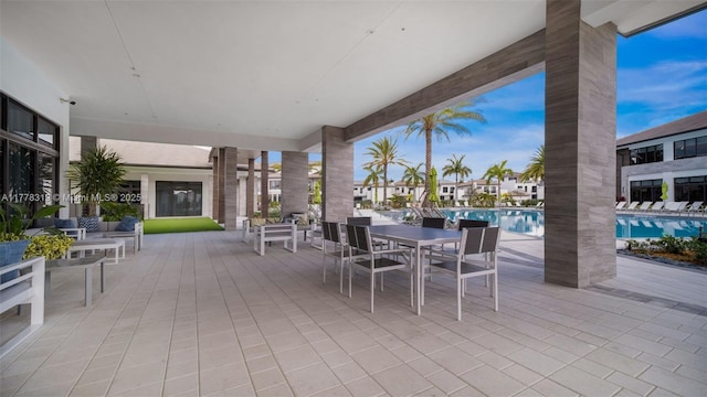 4740 NW 84th Ct Unit 32, Doral, FL 33166 - view of patio with outdoor dining area and a community pool