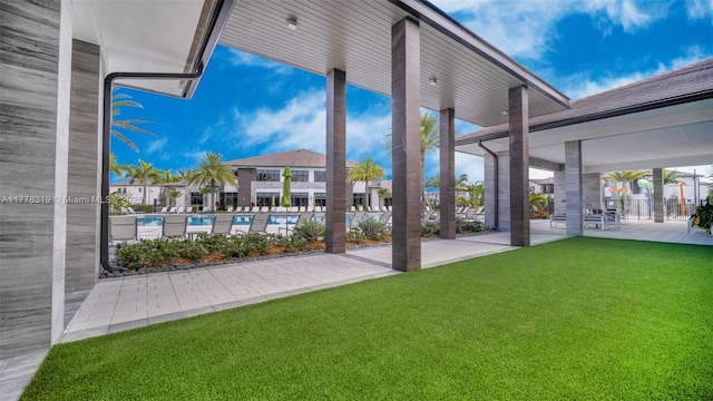 4740 NW 84th Ct Unit 32, Doral, FL 33166 - exterior space with a patio area, a lawn, a swimming pool, and fence