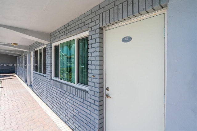 view of side of home with brick siding