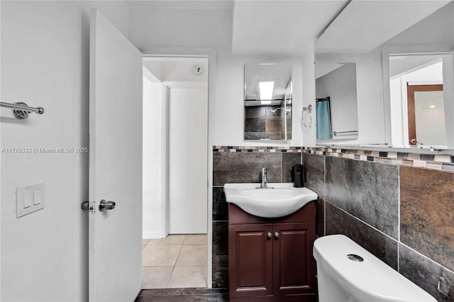 bathroom featuring vanity, tile patterned flooring, and toilet
