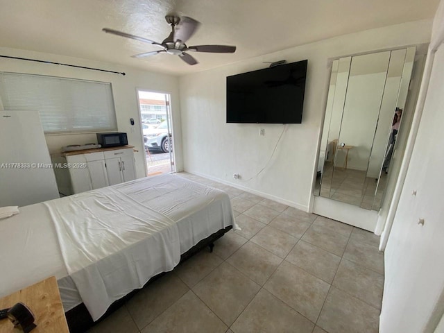 bedroom with baseboards, tile patterned flooring, and a ceiling fan