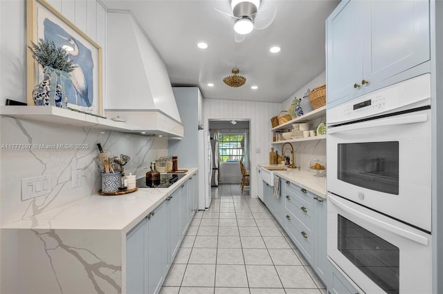 kitchen featuring open shelves, decorative backsplash, white double oven, and light tile patterned flooring