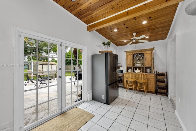 interior space featuring wooden ceiling, lofted ceiling with beams, freestanding refrigerator, french doors, and light tile patterned flooring