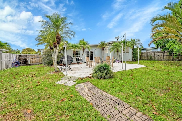 back of house featuring a patio, a fenced backyard, stucco siding, and a lawn