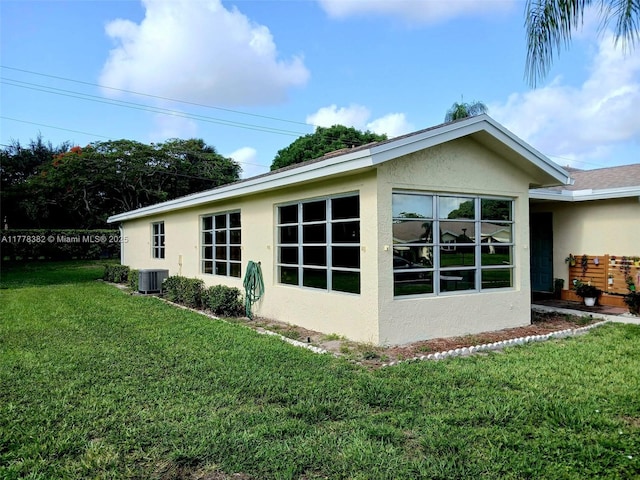 5054 Lakefront Blvd Unit A, Delray Beach, FL 33484 - view of side of property featuring stucco siding, a yard, and central AC unit