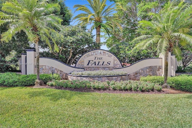 community sign featuring a yard