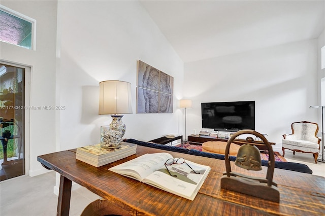 home office featuring high vaulted ceiling and baseboards