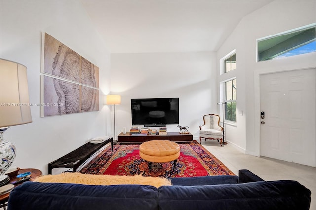 carpeted living area featuring lofted ceiling