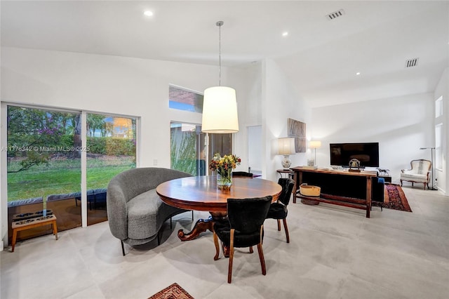 dining area with visible vents, a wealth of natural light, and high vaulted ceiling