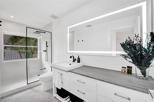 full bathroom with a walk in shower, toilet, visible vents, and vanity