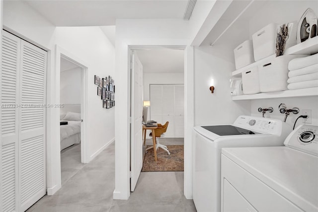 laundry area with visible vents, laundry area, and washer and clothes dryer