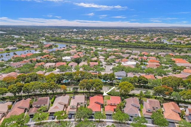 drone / aerial view featuring a residential view and a water view