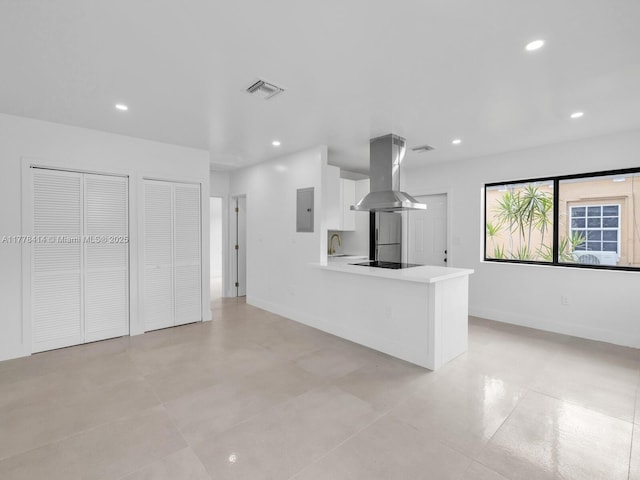 unfurnished living room featuring electric panel, a sink, visible vents, and recessed lighting