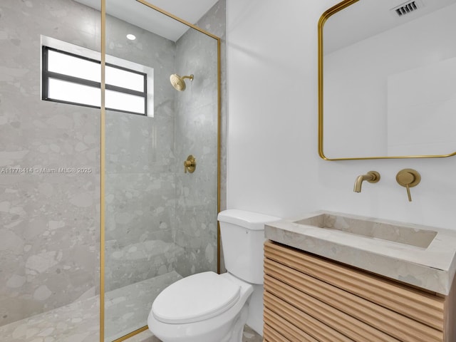 bathroom featuring visible vents, toilet, a walk in shower, and vanity