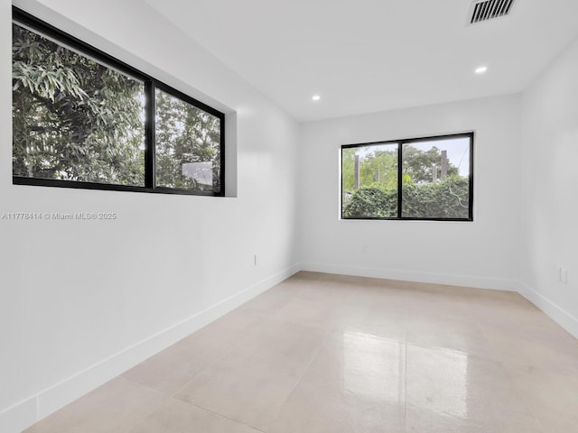 spare room featuring recessed lighting, visible vents, and baseboards
