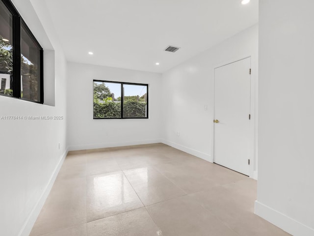 empty room with baseboards, visible vents, and recessed lighting