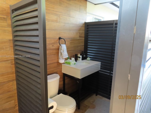 half bath featuring toilet and vanity
