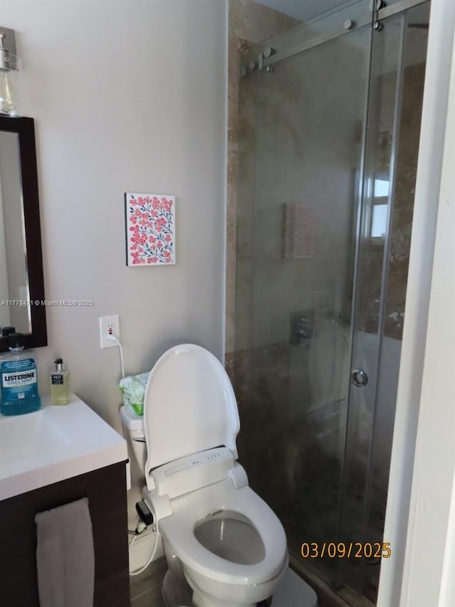 full bath with toilet, a stall shower, and vanity