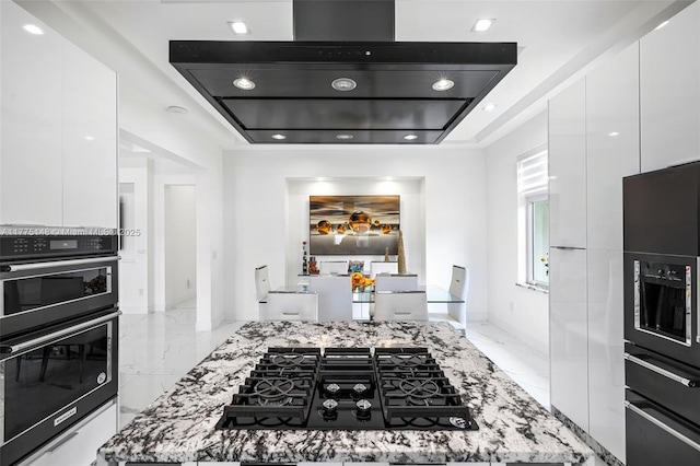 5815 SW 107th Pl, Miami, FL 33173 - kitchen with modern cabinets, white cabinetry, black appliances, and exhaust hood