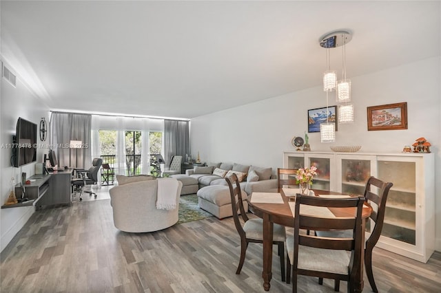 dining space with visible vents and wood finished floors
