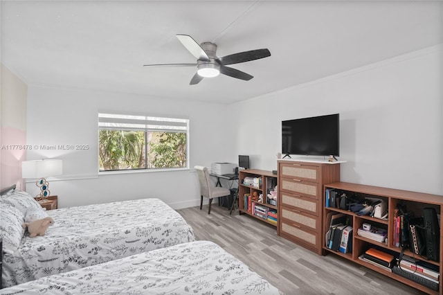 bedroom with baseboards, wood finished floors, and a ceiling fan