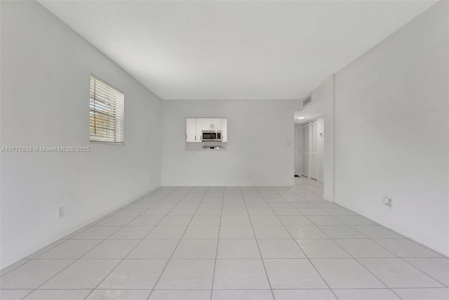 spare room with visible vents and light tile patterned floors