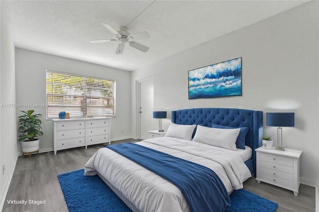 bedroom with baseboards, wood finished floors, and a ceiling fan