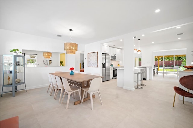 dining space with baseboards, visible vents, and recessed lighting