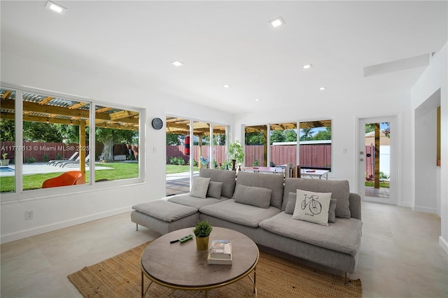 living room with recessed lighting and baseboards