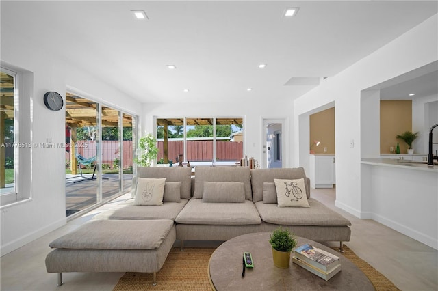 living area with baseboards and recessed lighting