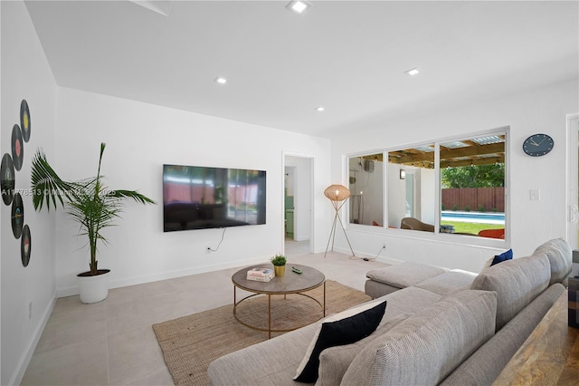 tiled living room featuring baseboards and recessed lighting
