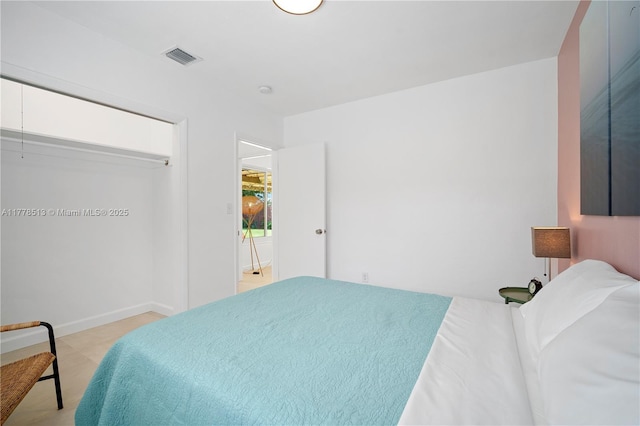 bedroom with baseboards and visible vents