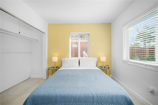 bedroom featuring a closet and baseboards