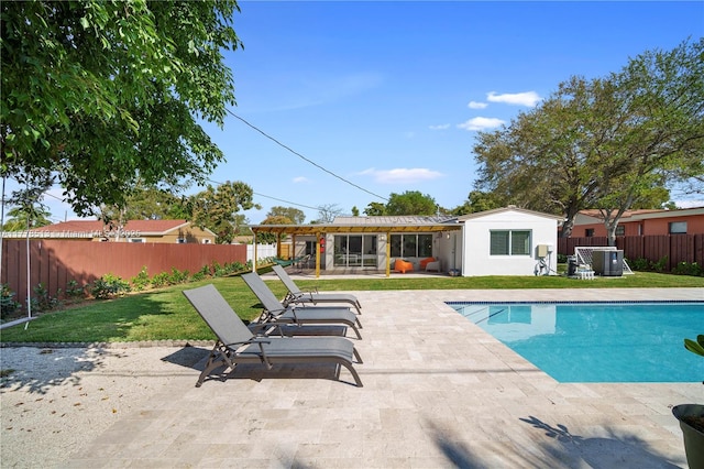 view of pool with a patio area, a yard, a fenced backyard, and a hot tub