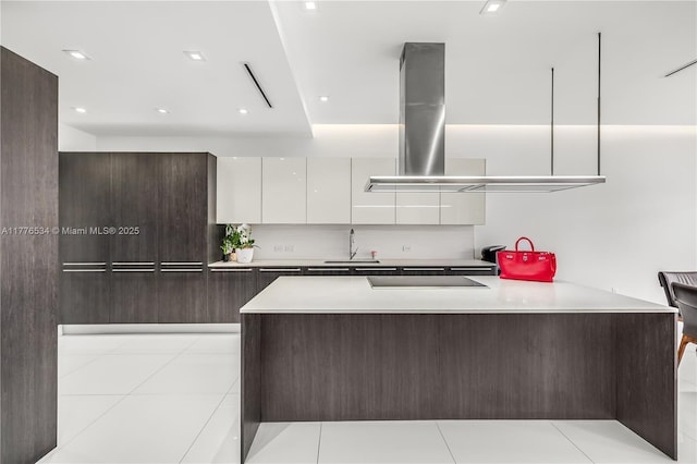 3106 NE 210th Ter, Aventura, FL 33180 - kitchen featuring modern cabinets, white cabinetry, light countertops, a peninsula, and range hood