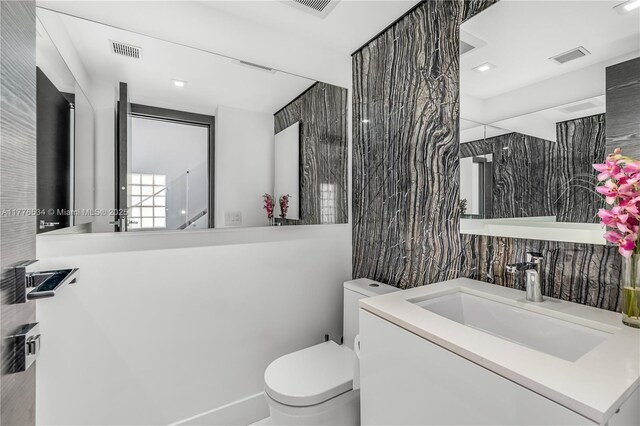 3106 NE 210th Ter, Aventura, FL 33180 - bathroom featuring toilet, tile walls, and vanity