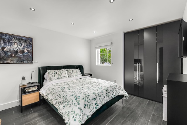 3106 NE 210th Ter, Aventura, FL 33180 - bedroom featuring a closet, dark wood-type flooring, recessed lighting, and baseboards