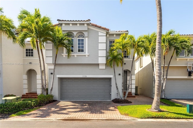 3106 NE 210th Ter, Aventura, FL 33180 - view of front of home featuring stucco siding, decorative driveway, an attached garage, and a tile roof