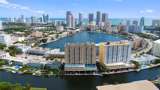 drone / aerial view featuring a view of city and a water view